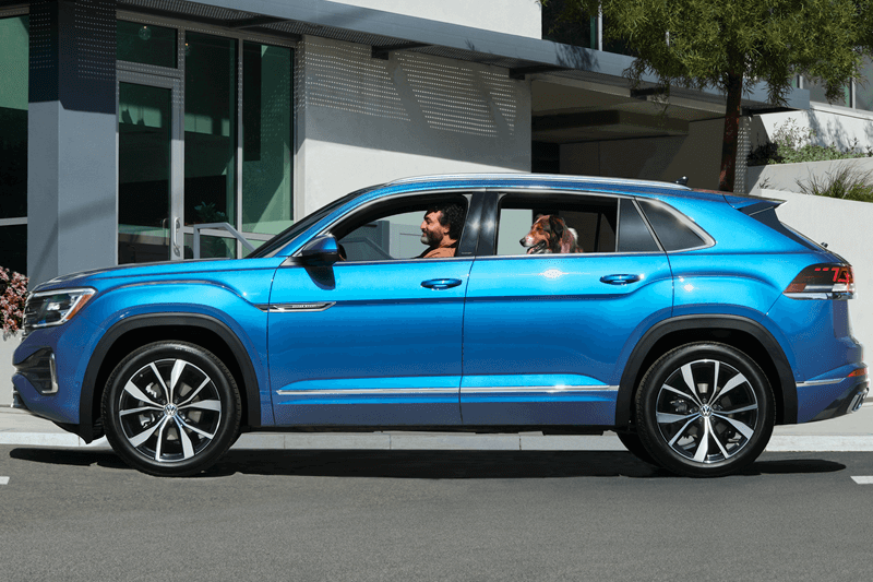 Volkswagen SUV parked on street next to coffee shop