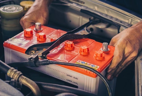 Battery being replaced in engine bay